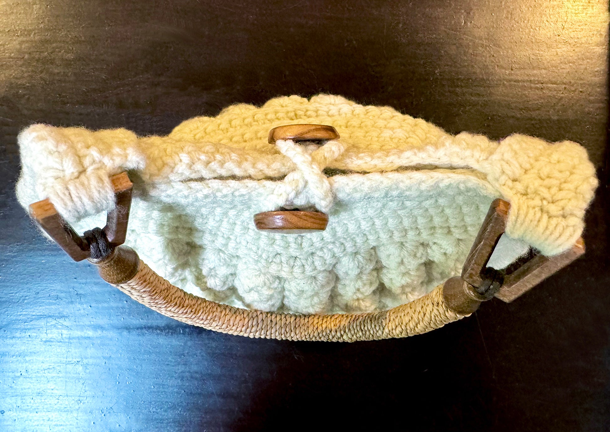 Bali's beautiful bamboo forests reflect in this Boho chic, hand crocheted bag by Oda G. exclusively for MarVia Square. Eco-conscious with up-cycled, cotton blend yarn, raffia handles, bamboo hooks, and buttons. Dimensions: Height: 15"(to top of handle), Length: 10" Width: 4" Color: Cream Hand wash, cold, or dry clean Made in California Can be special ordered in other colors if available. Please email us your color request and allow 3 to 4 weeks to complete.