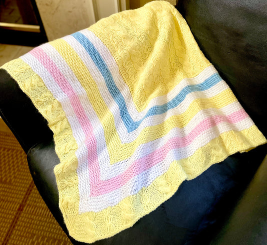 Soft pastel colors of pink, blue and yellow is the perfect trio to brighten up your baby girl's room. Hand knit cable and pearl design with the softest acrylic up-cycled yarn. Only one in this style to make this the most special gift. Dimensions: 36" x 36" Hand wash cold, Line dry Made with love in the USA