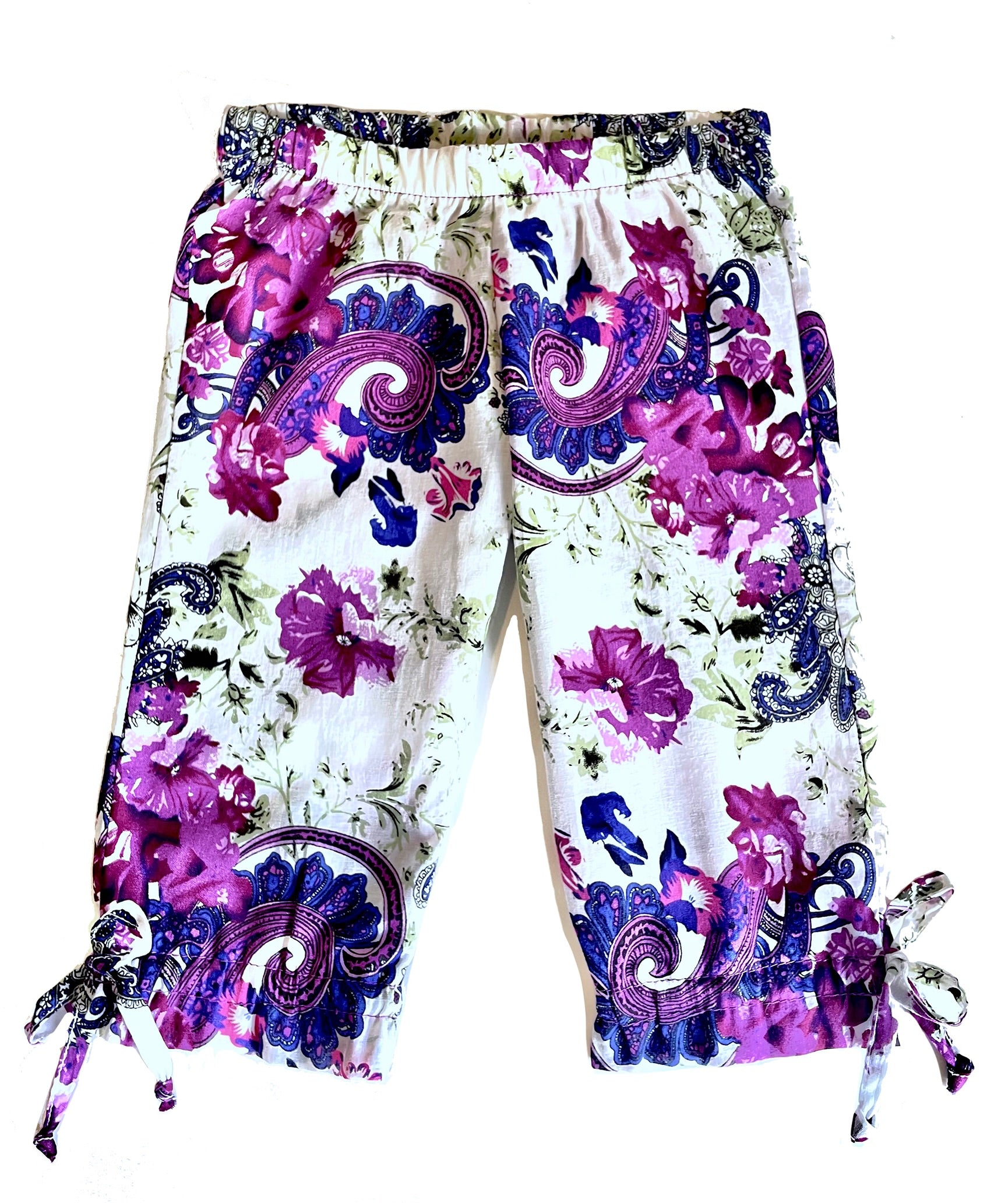 Colorful purple paisley-floral print on soft, light weight cotton woven fabric, make these capri pants so comfortable and fun to wear in the summer.  Soft elastic waist, with ties at the ankle.  Pair with the Gatsby Girl Capri Halter top for a cool & comfy summer fun look. 