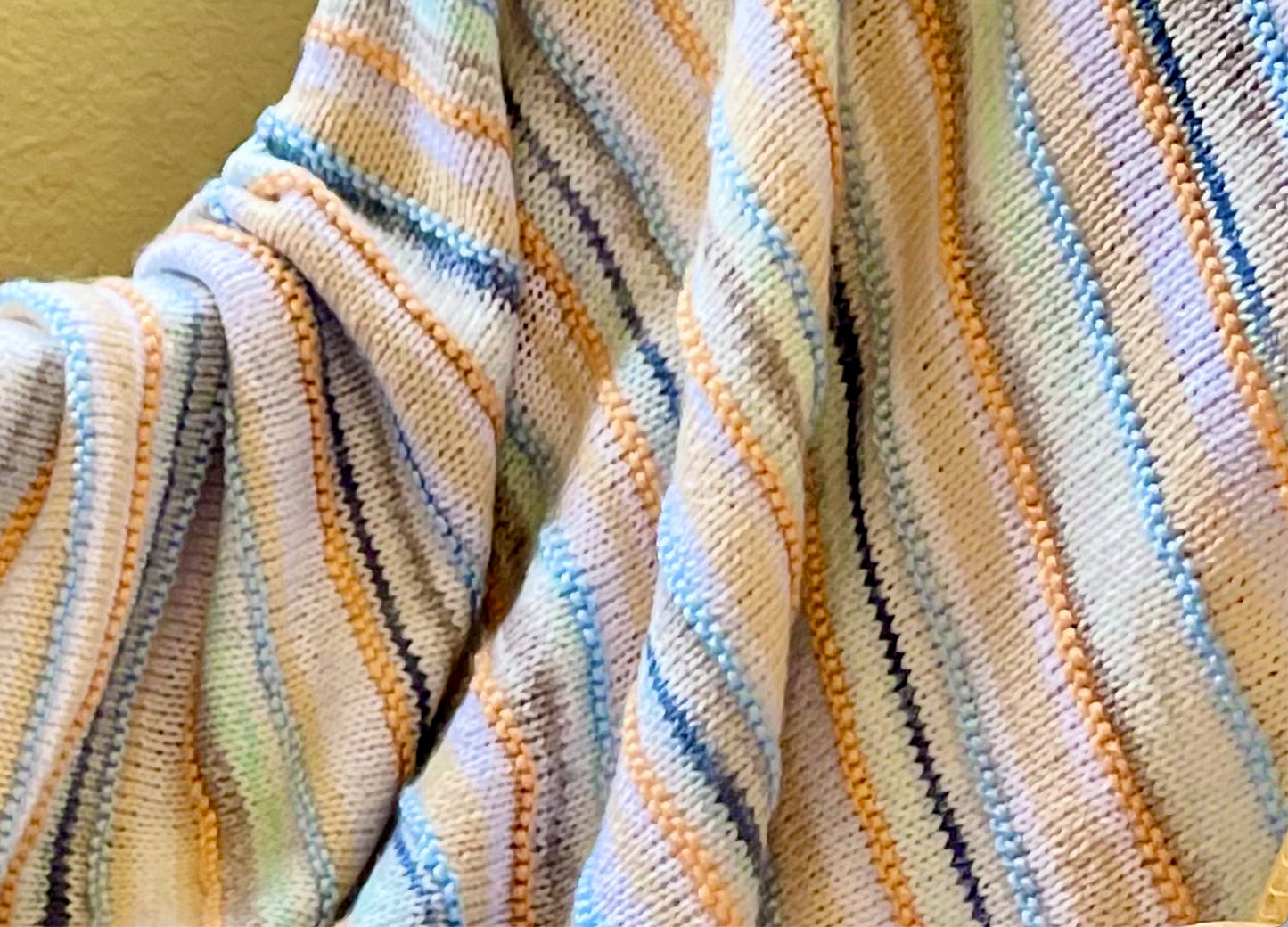 Malibu beach colors of pastel blues, greens, and earth tones are blended together in this soft, hand knit baby blanket.  A perfect one-of-a-kind gift for baby. 