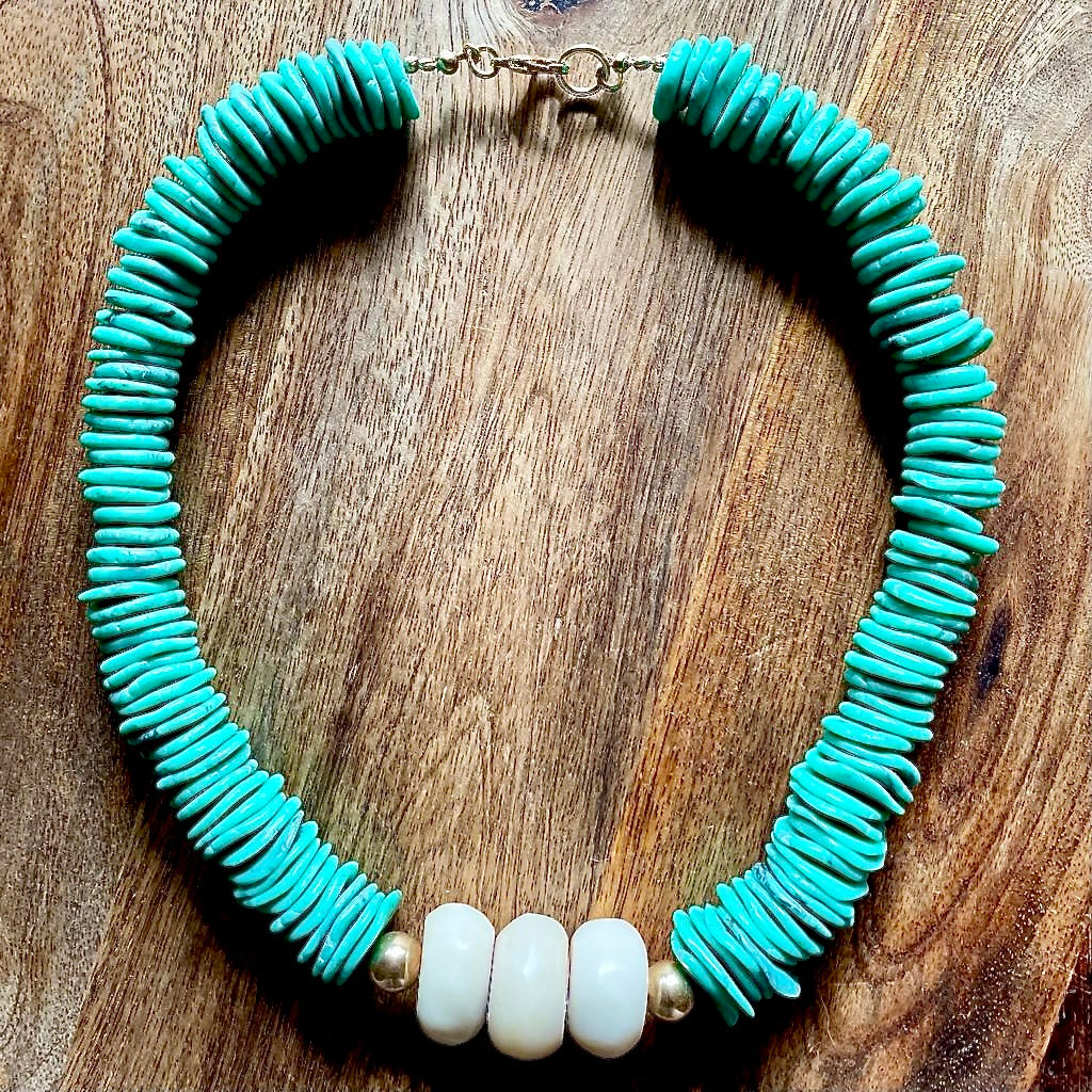 A statement piece for any occasion, this eye-catching necklace features turquoise disc beads, reminiscent ceremonial necklaces of indigenous people and range in size from 10mm - 18mm in diameter. The gold filled beads measure 10mm and the African beads measure 24mm.  Total length of the necklace is 20 inches.