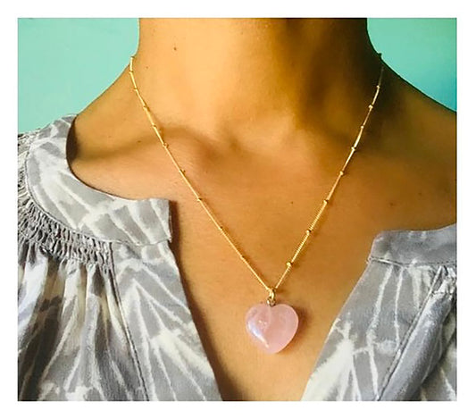 Corazon means 'Heart' in Spanish, and this rose quartz heart necklace is the perfect piece to bring more love into your life.&nbsp; Heart pendant measures 17mm x 16mm, 5m thick, and has a silver loop for the chain.&nbsp; Size may vary slightly from pendant to pendant.&nbsp; Gold filled, 18" satellite chain may be subst…