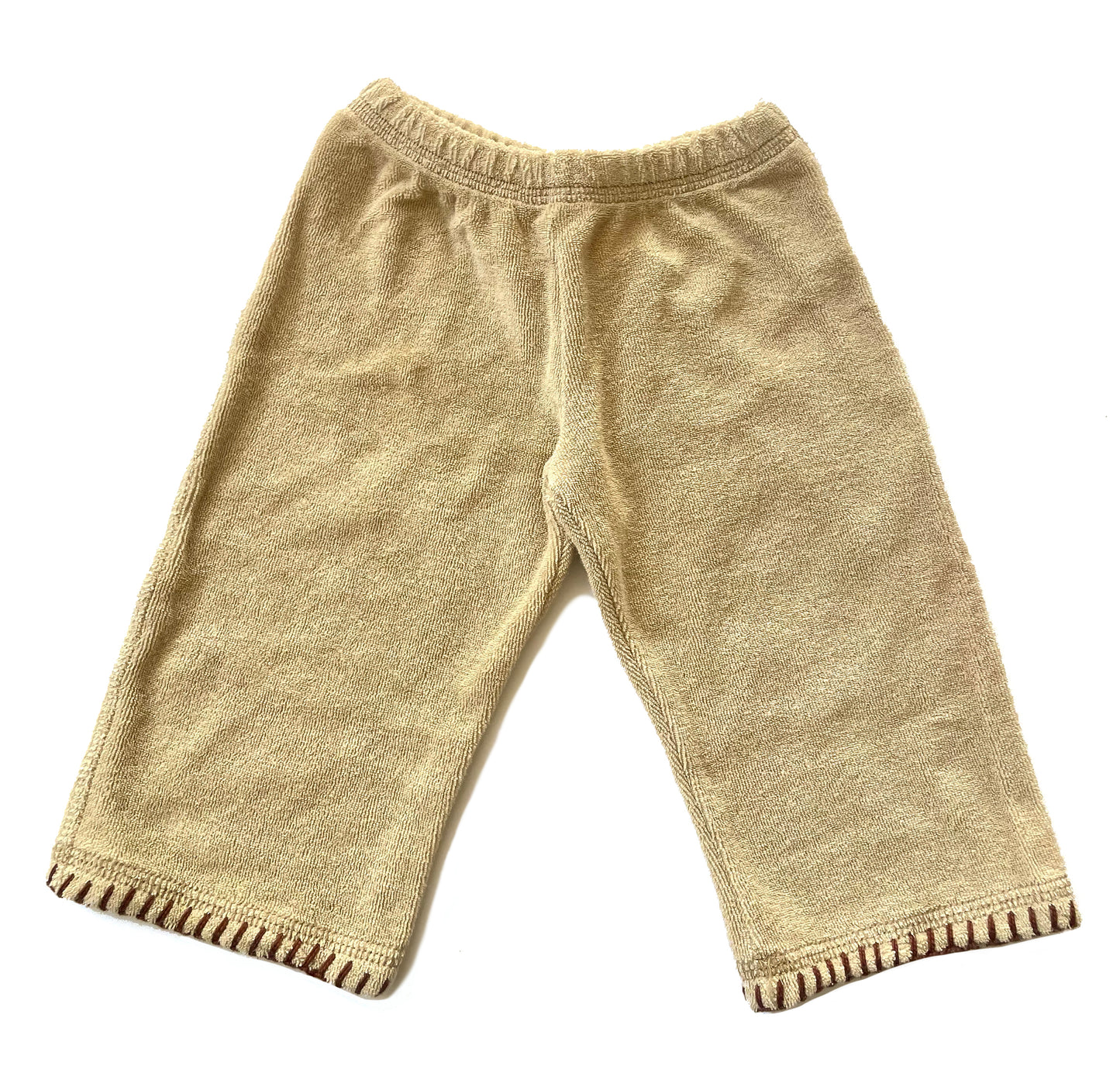 Cozy cover up 'aprés beach' set in the softest, cotton terry fabric with blanket stitch trim detail on both hoodie and elastic waist pant. Kanga pocket on hoodie for little treasures. Fabric color: Sand / Trim color: Chocolate 85% Cotton / 15% Poly Machine washable, cold. Dry on low heat. Made in California